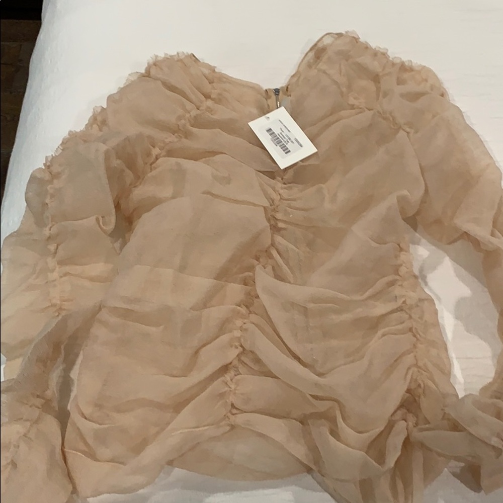 Ruffled nude blouse